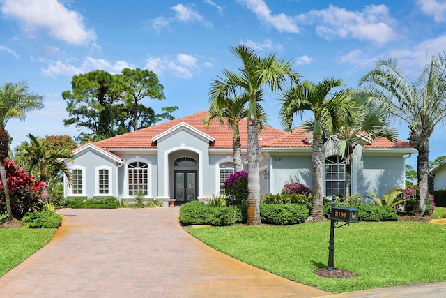 mediterranean / spanish house featuring a front yard