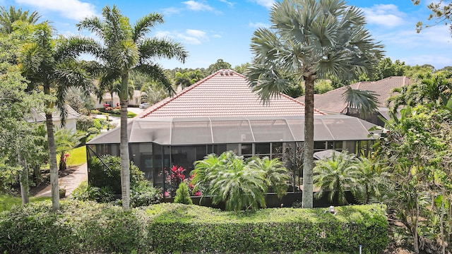 view of property exterior featuring glass enclosure