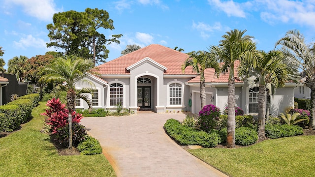 mediterranean / spanish-style home featuring a front yard