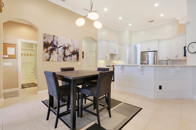 tiled dining space with ornamental molding and sink