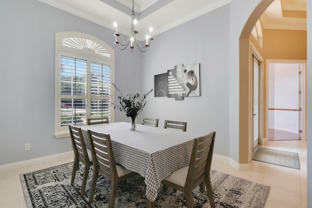 tiled dining space featuring ornamental molding and a notable chandelier