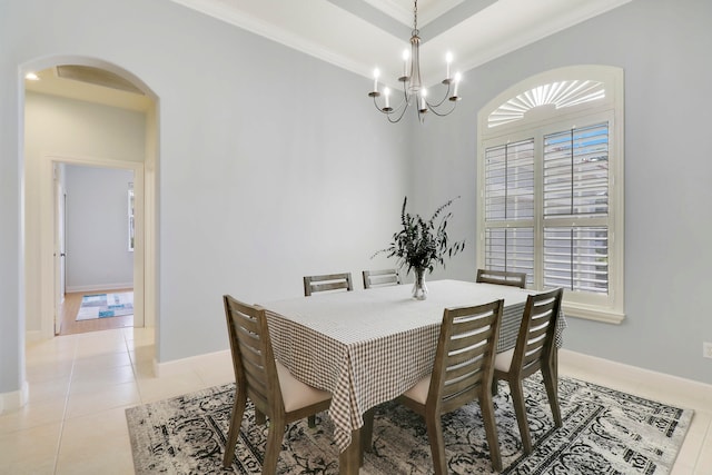 dining area with crown molding, light tile patterned floors, and an inviting chandelier