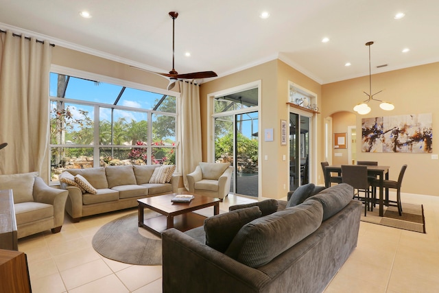 living room featuring ceiling fan, ornamental molding, and light tile patterned floors