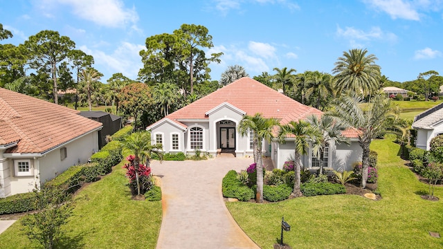 mediterranean / spanish house with a front lawn