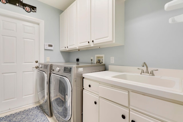 washroom with cabinets, sink, separate washer and dryer, and light tile patterned floors