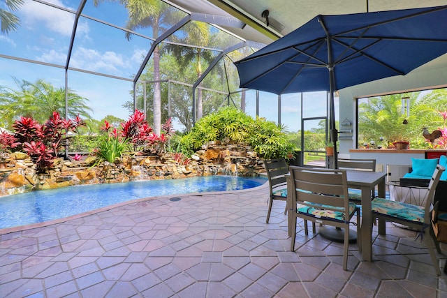 view of patio / terrace featuring pool water feature and glass enclosure