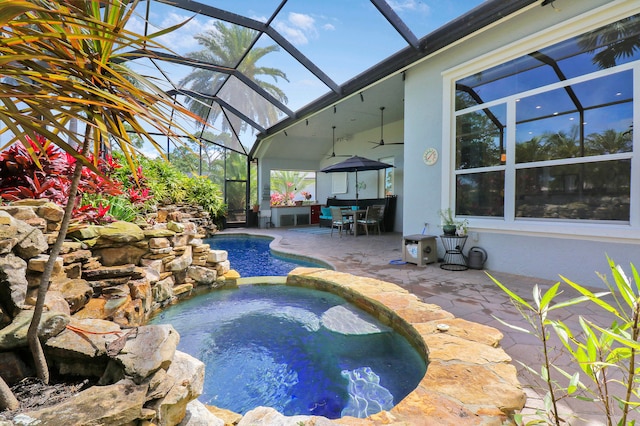 view of pool featuring a patio, a lanai, and an in ground hot tub