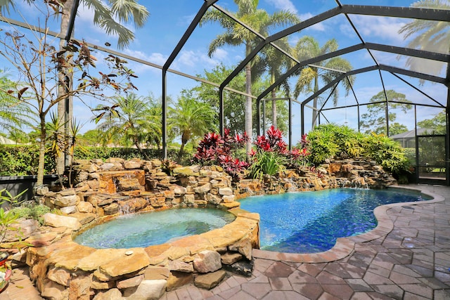 view of pool with an in ground hot tub, pool water feature, and a lanai