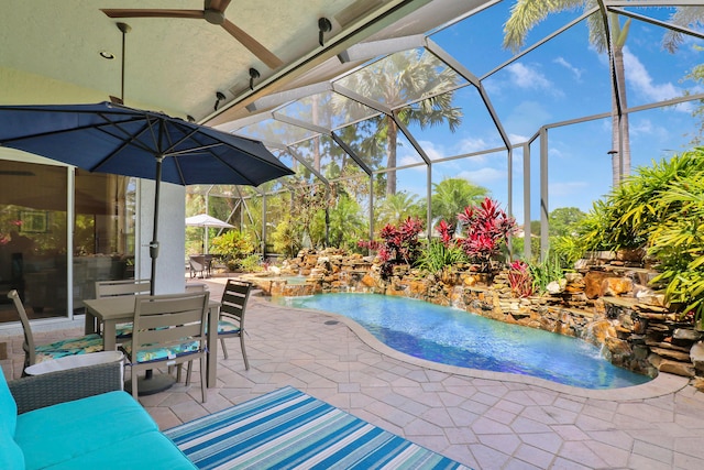 view of pool featuring pool water feature, a patio area, and glass enclosure