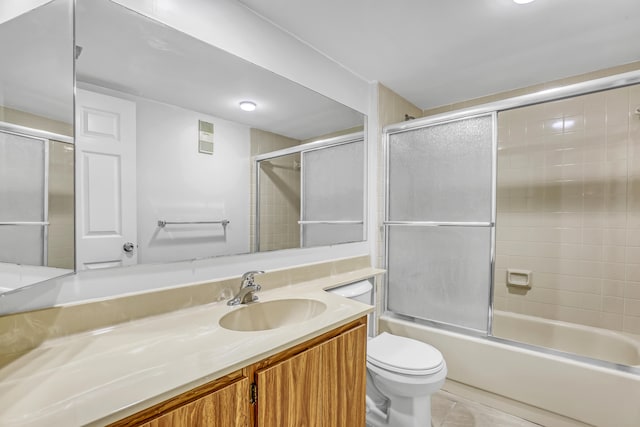 full bathroom with vanity, toilet, tile patterned floors, and enclosed tub / shower combo