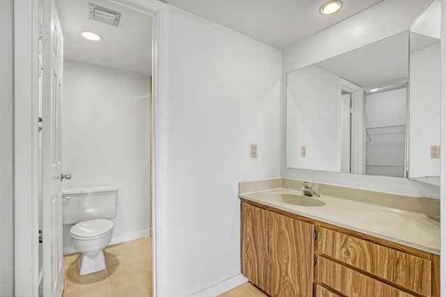 bathroom featuring vanity, toilet, and tile patterned floors