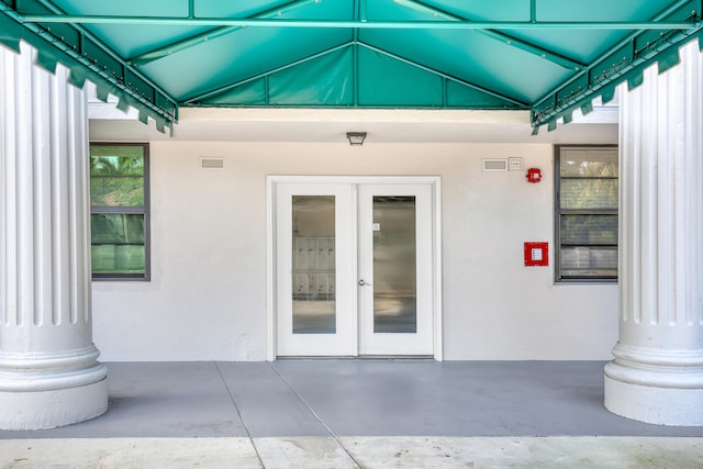 property entrance with a patio and french doors