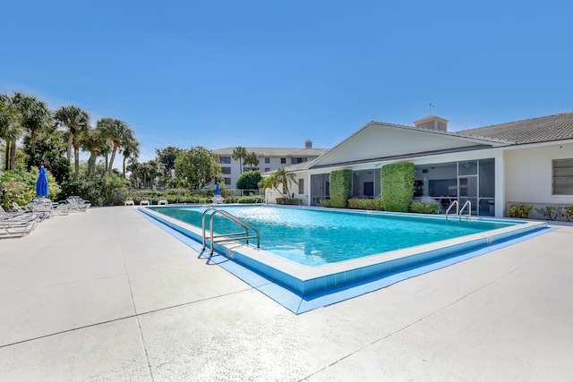 view of swimming pool with a patio