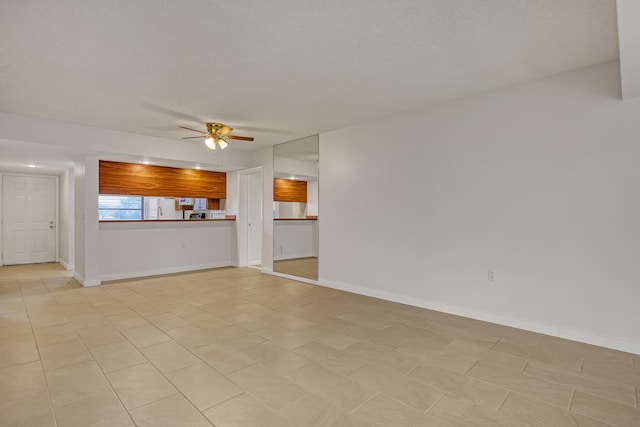 unfurnished living room featuring ceiling fan and light tile patterned floors