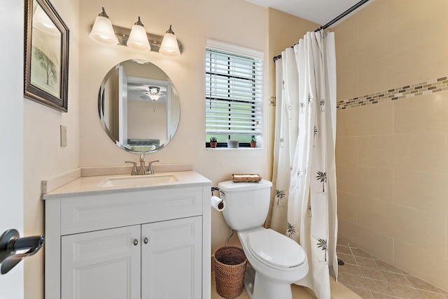 bathroom featuring toilet, curtained shower, and vanity