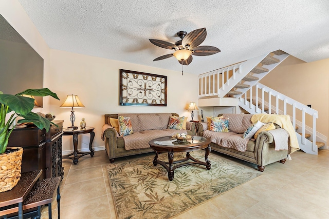 tiled living room with a textured ceiling and ceiling fan