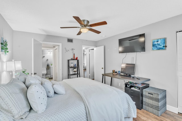 bedroom with light hardwood / wood-style flooring, ceiling fan, and connected bathroom