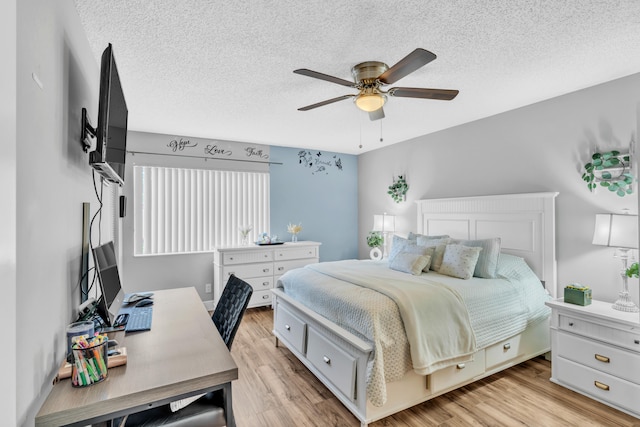 bedroom with ceiling fan, a textured ceiling, and light hardwood / wood-style flooring