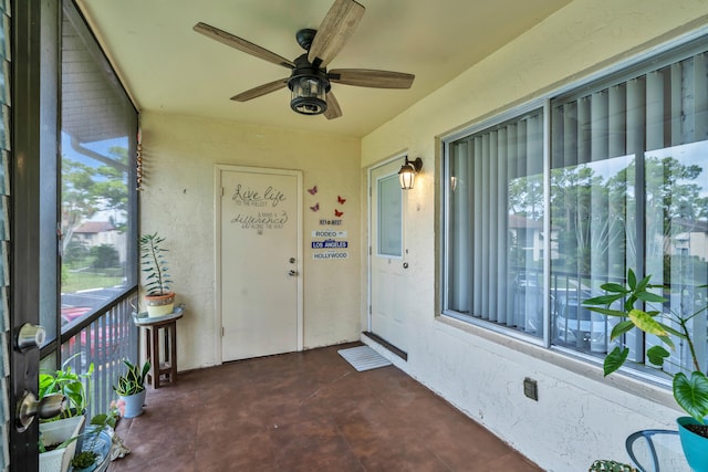 view of exterior entry with ceiling fan