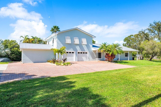 view of front of house with a front lawn and a garage