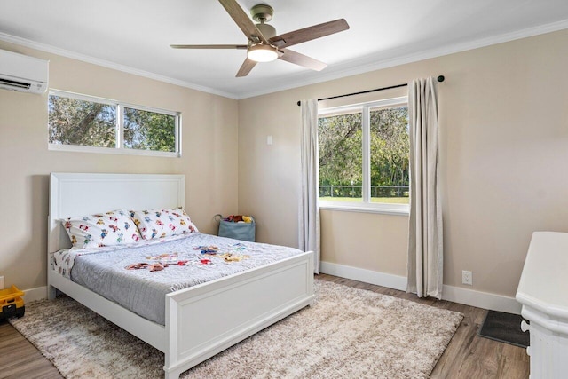 bedroom featuring a wall unit AC, wood-type flooring, crown molding, and ceiling fan