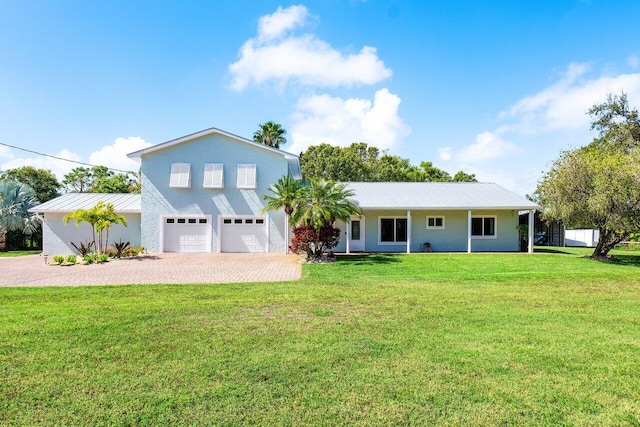 view of front of property with a front yard and a garage