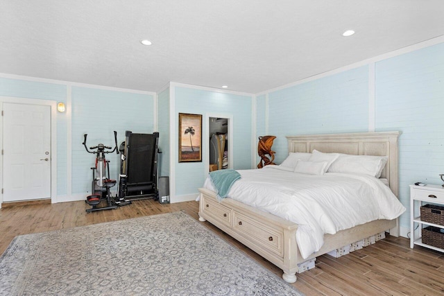 bedroom featuring crown molding and light wood-type flooring