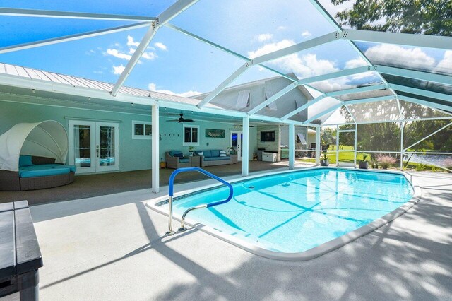 view of pool with french doors, a patio, glass enclosure, and ceiling fan