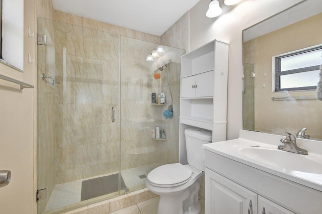 bathroom with a shower with shower door, vanity, toilet, and tile patterned flooring