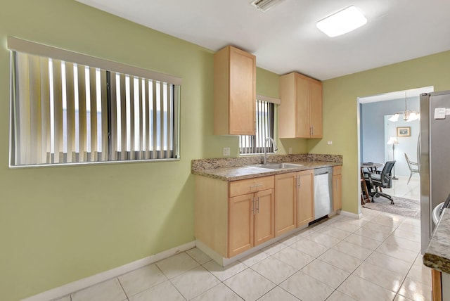 kitchen with light tile patterned floors, a notable chandelier, light brown cabinets, sink, and stainless steel dishwasher