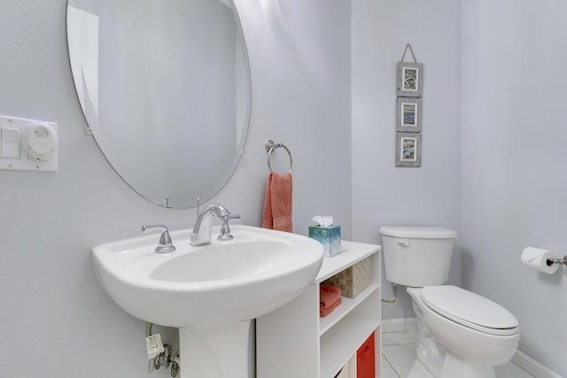 bathroom with tile patterned flooring and toilet