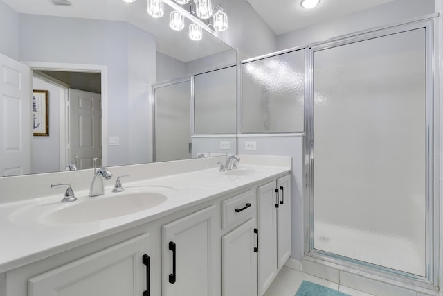 bathroom with tile patterned flooring, vanity, and a shower with shower door