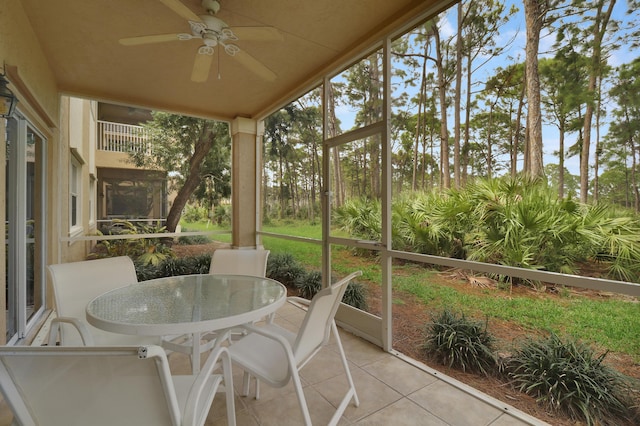 sunroom / solarium featuring ceiling fan