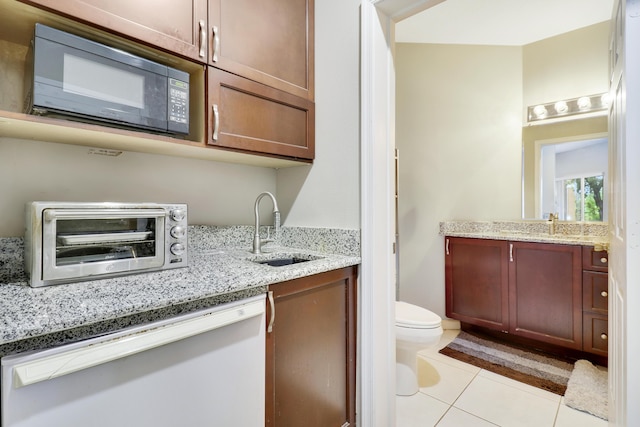 bathroom with tile patterned floors, vanity, and toilet