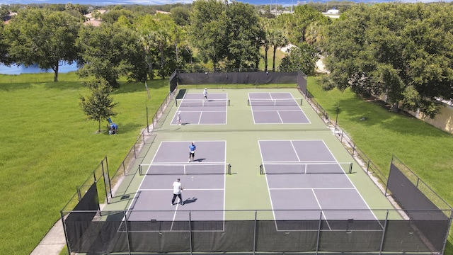 view of sport court with a lawn