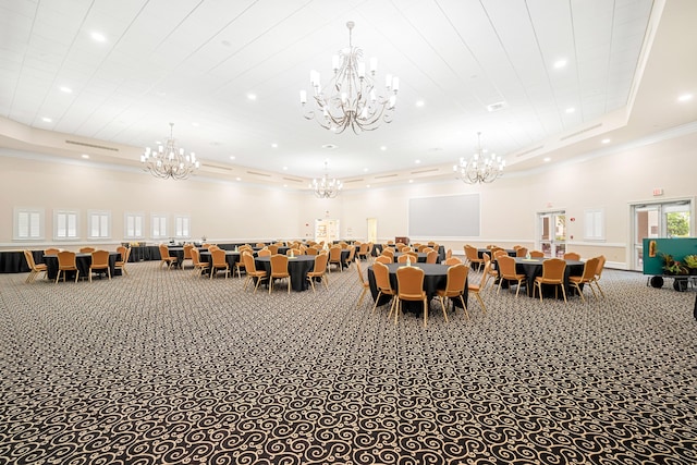 carpeted dining space featuring a high ceiling, a raised ceiling, and ornamental molding