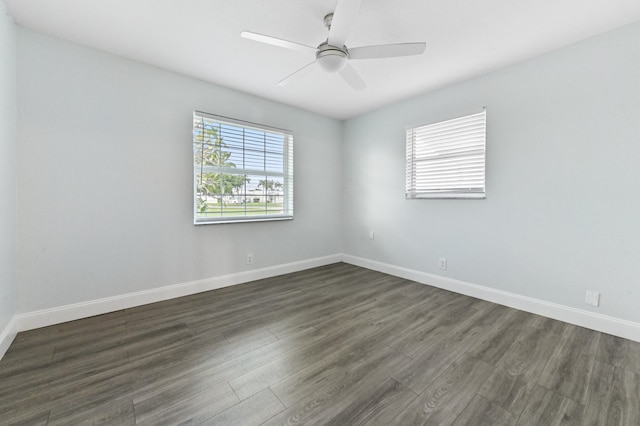 spare room with dark wood-type flooring and ceiling fan