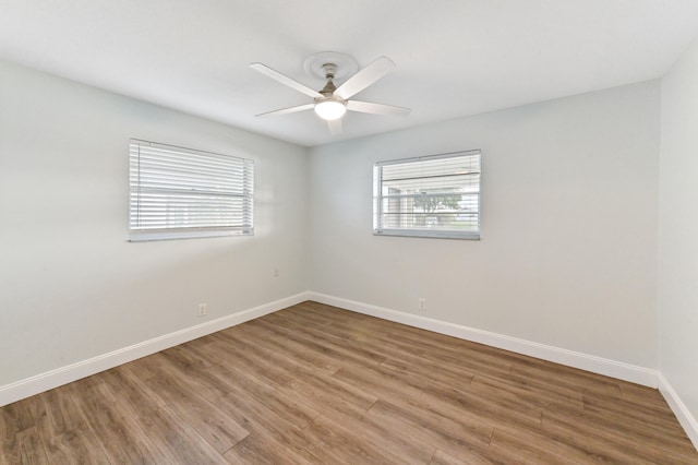 unfurnished room with hardwood / wood-style flooring and ceiling fan