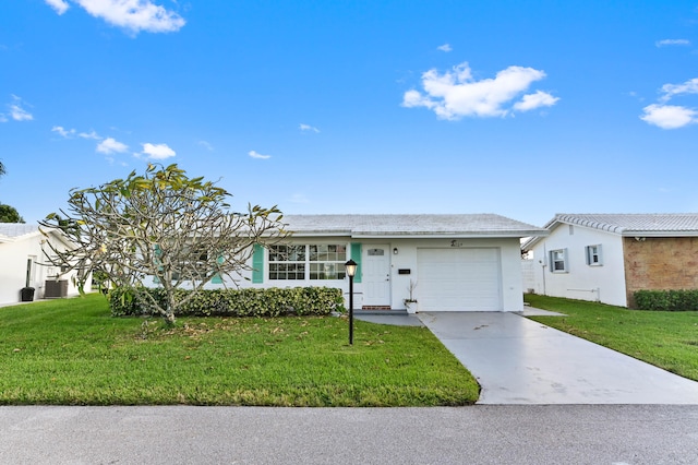 single story home with a front yard and a garage