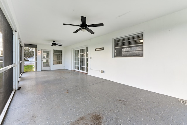 unfurnished sunroom featuring french doors and ceiling fan