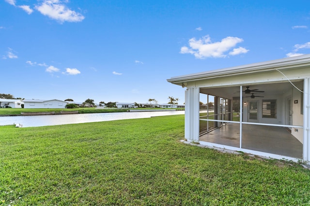 view of yard featuring a water view and ceiling fan