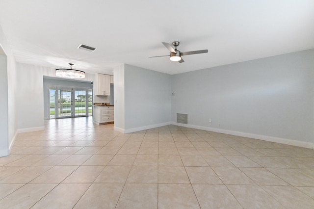 tiled spare room featuring ceiling fan