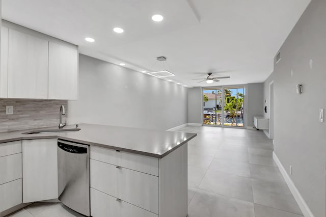 kitchen featuring backsplash, sink, white cabinets, dishwasher, and ceiling fan