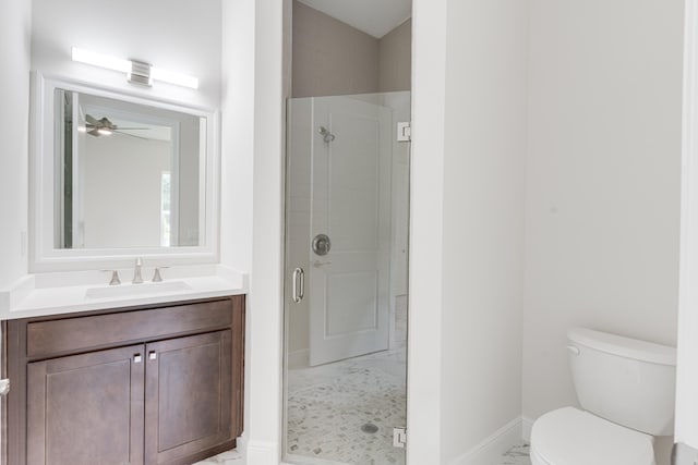 bathroom featuring a shower with door, vanity, toilet, and ceiling fan