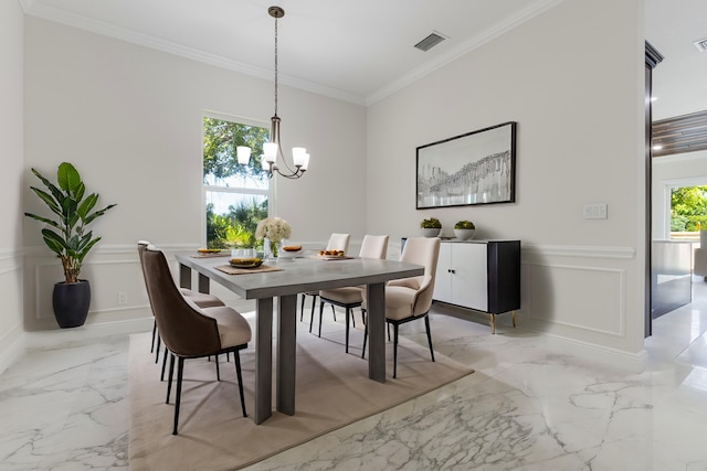 dining space with a healthy amount of sunlight, ornamental molding, and an inviting chandelier