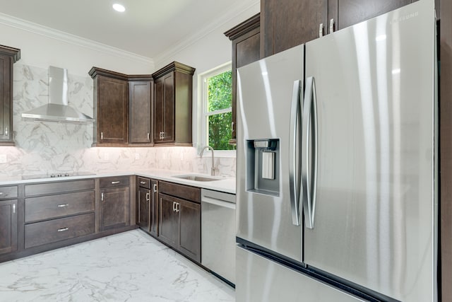 kitchen featuring decorative backsplash, wall chimney range hood, sink, dark brown cabinetry, and appliances with stainless steel finishes