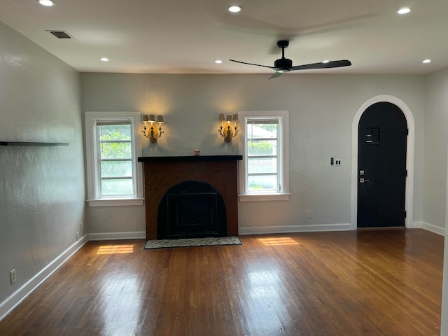 unfurnished living room with wood-type flooring and ceiling fan