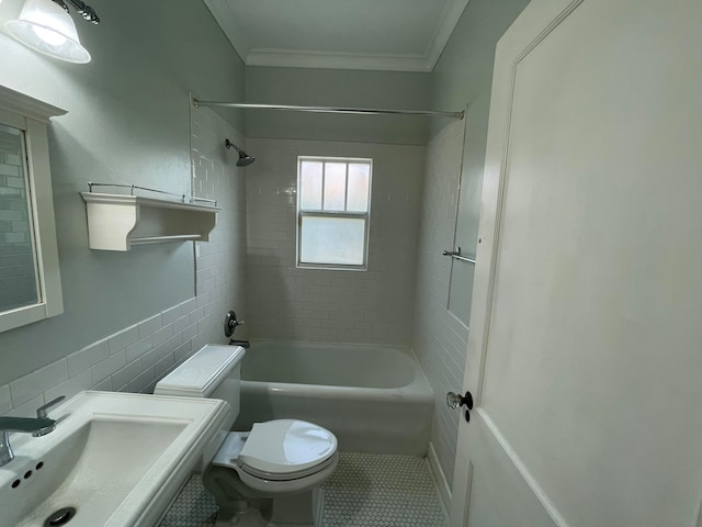 full bathroom with tiled shower / bath, tile patterned floors, crown molding, and toilet