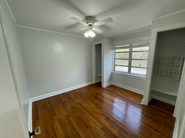 unfurnished bedroom featuring crown molding, dark wood-type flooring, and ceiling fan