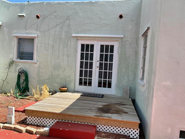 doorway to property with a wooden deck and french doors